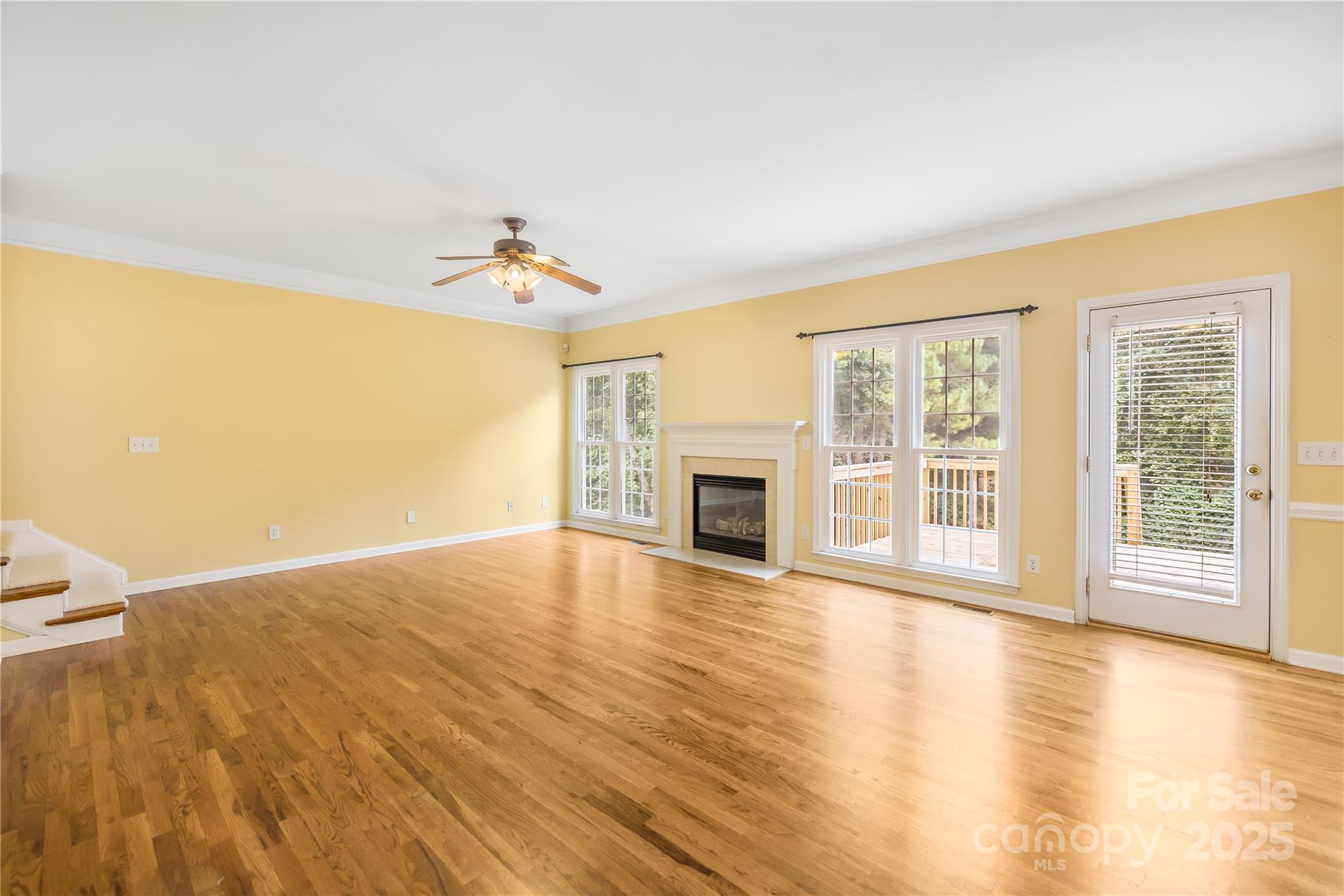 17112 Cambridge Grove Drive Huntersville, NC 28078 - Photo 7 of 44 a view of an empty room with wooden floor and a window