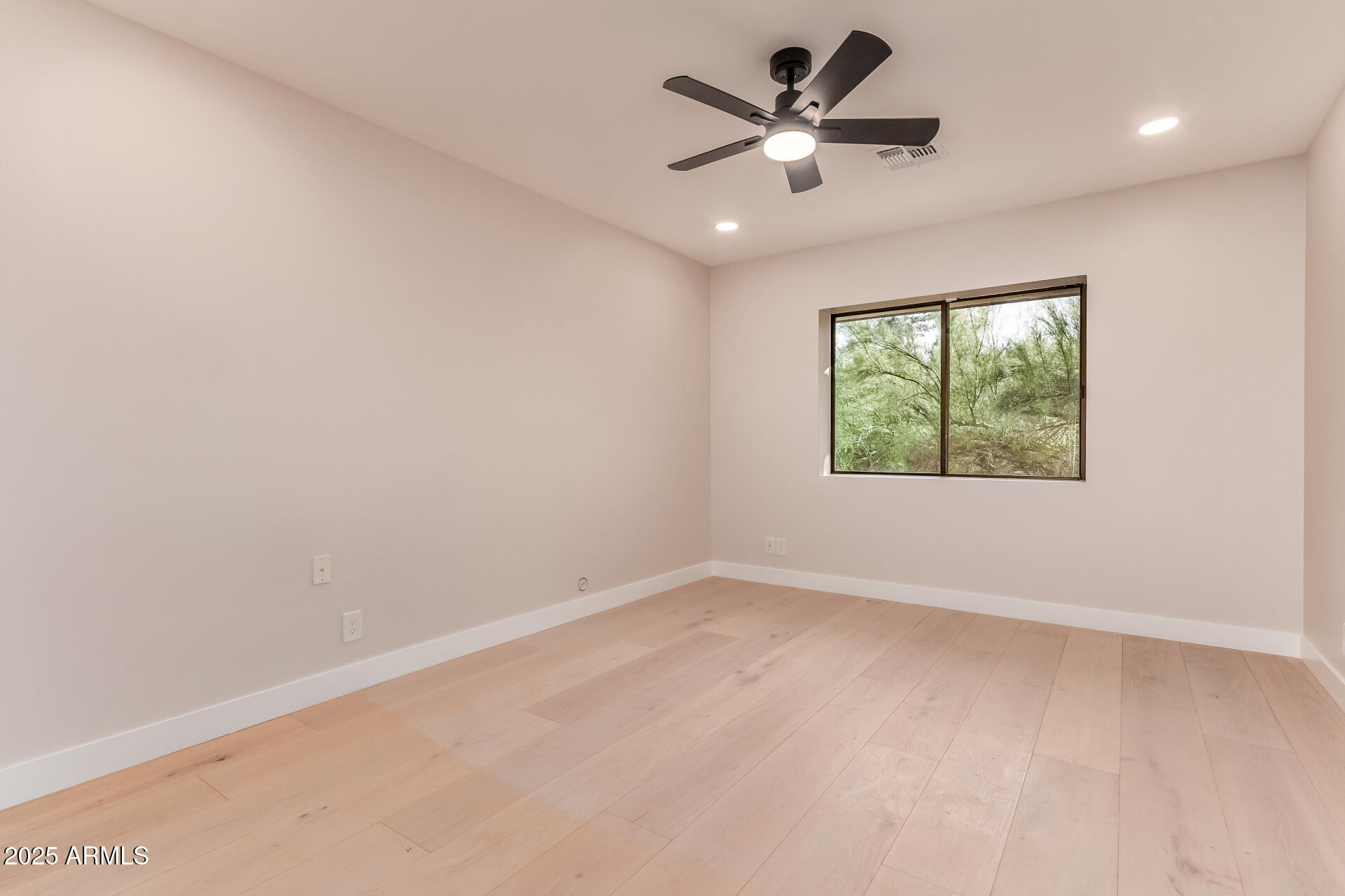 3301 East Rovey Avenue Paradise Valley, AZ 85253 - Photo 49 of 105 an empty room with windows and ceiling fan