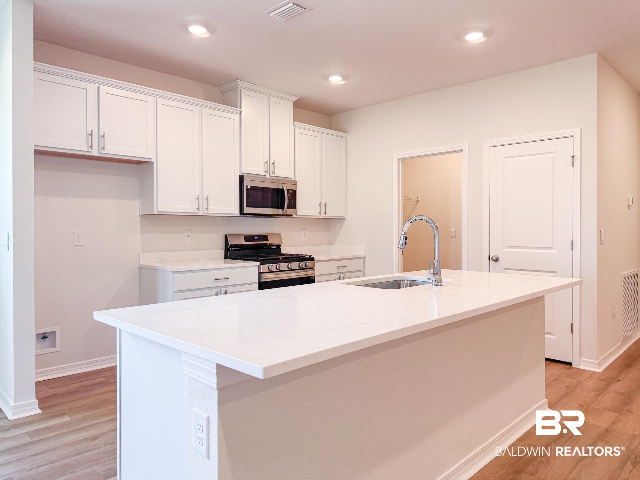 18151 Kent Circle Foley, AL 36535 - Photo 6 of 25 Contemporary kitchen featuring a large central island with an undermount sink and gooseneck faucet