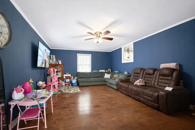 a living room with furniture chess board and a window