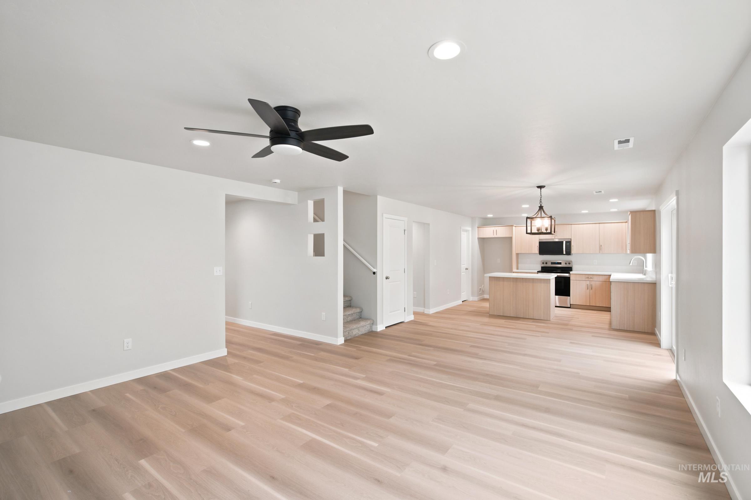 472 Merlin Court Middleton, ID 83644 - Photo 8 of 25 Recessed ceiling lighting, wood-finish flooring, a modern ceiling fan, and a front entry door with integrated hardware