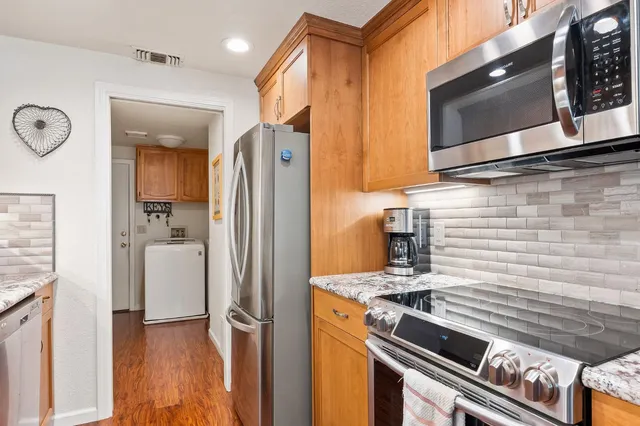a kitchen with a refrigerator stove and microwave