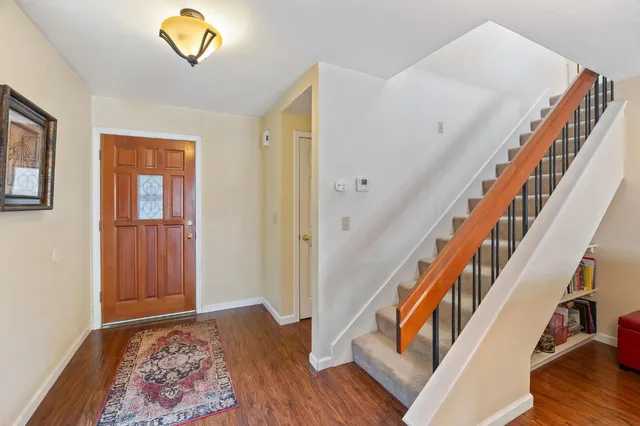 a view of an entryway with wooden floor