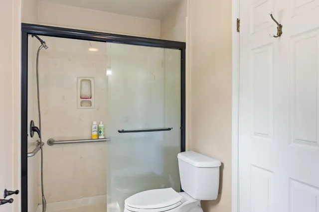 a bathroom with a toilet and a shower