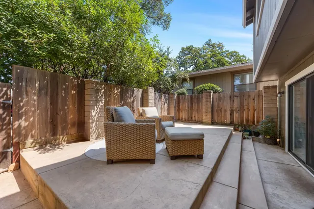 a patio with couches and a fire pit
