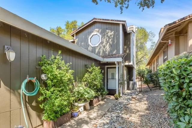 a view of a house with fountain and plants