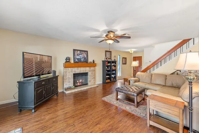 a living room with furniture a fireplace and a flat screen tv