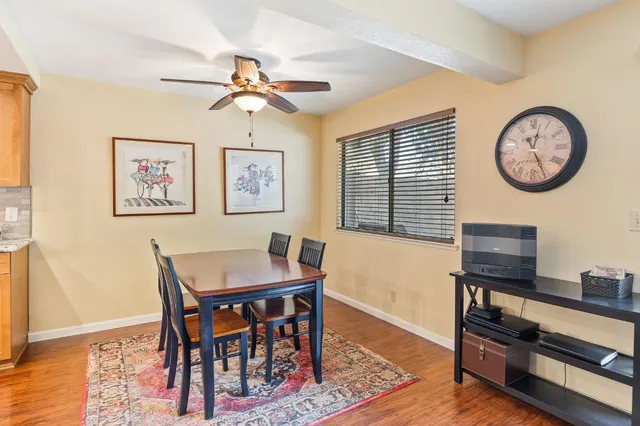 a view of a dining room with furniture window and wooden floor