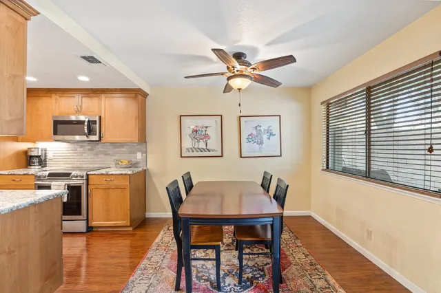 a view of a dining room with furniture and a kitchen