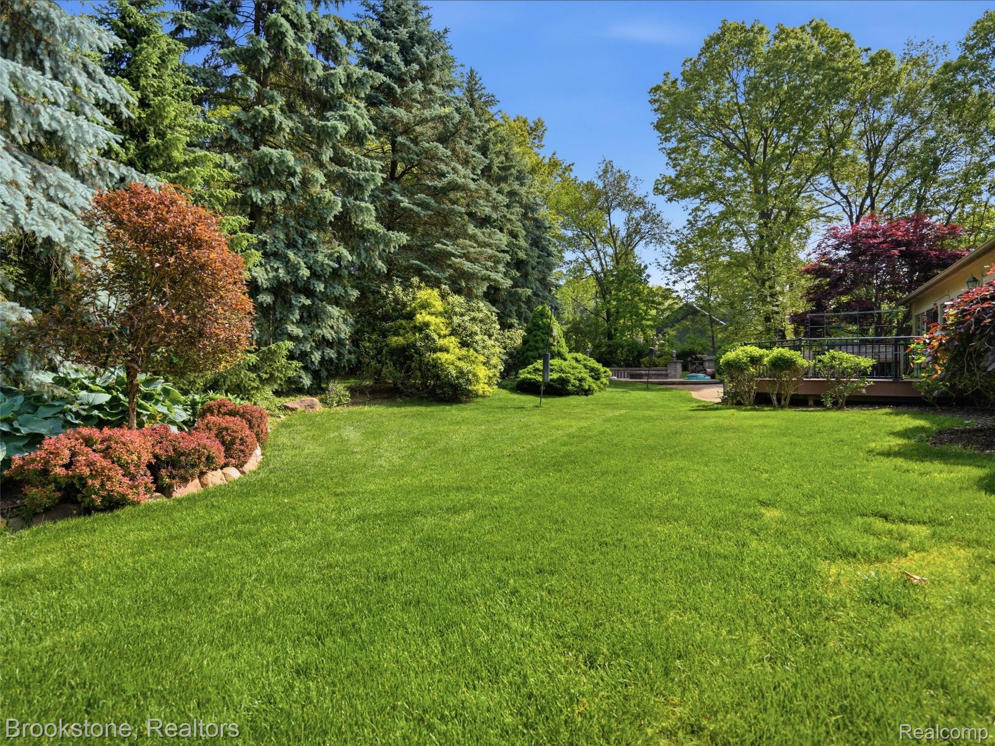 9523 Quail Ridge Run Brighton, MI 48114 - Photo 49 of 50 Expansive lawn area featuring mature trees and established landscaping