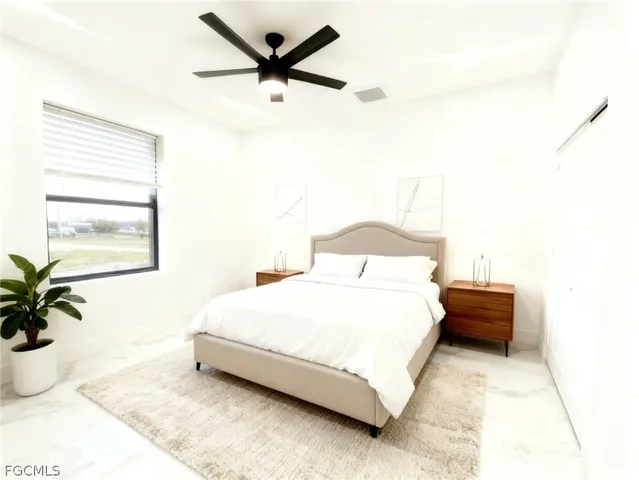 a bedroom with a bed plant and a window