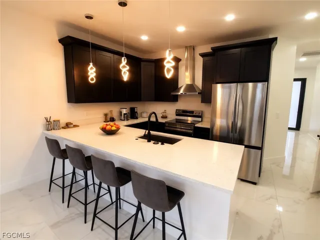 a kitchen with stainless steel appliances a refrigerator and a microwave
