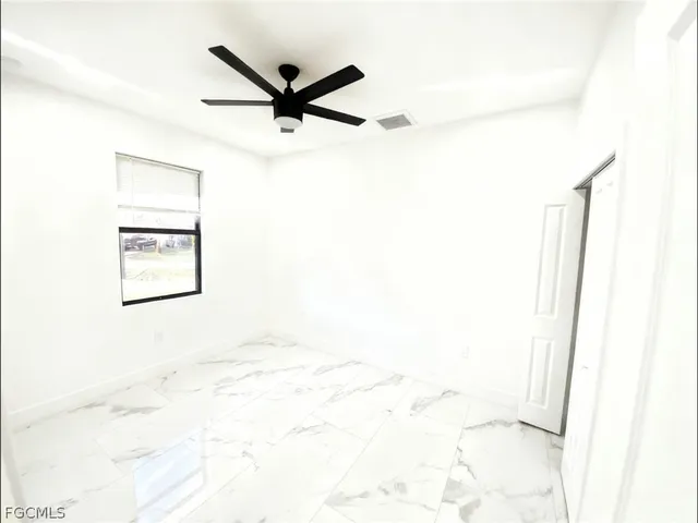 a view of a ceiling fan and a window