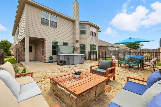 a outdoor space with patio the couches and a fireplace