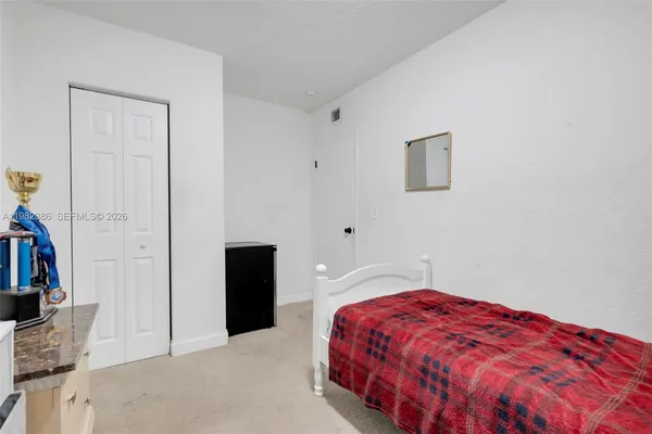a bedroom with a bed and a closet