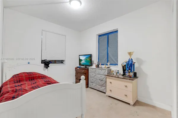 a bedroom with a bed and a dresser