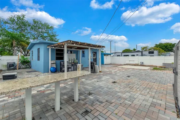a view of a house with a yard and sitting area