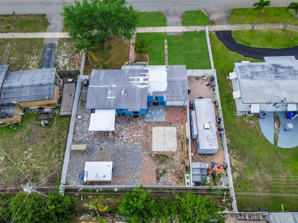 an aerial view of residential houses with outdoor space and parking