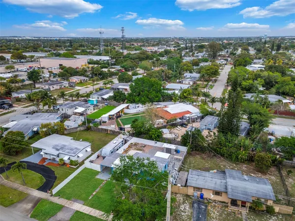 an aerial view of residential houses with outdoor space