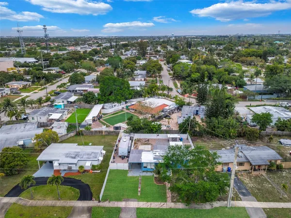 an aerial view of residential houses with outdoor space and river