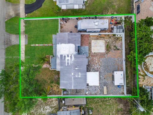 an aerial view of a house with a garden and a building