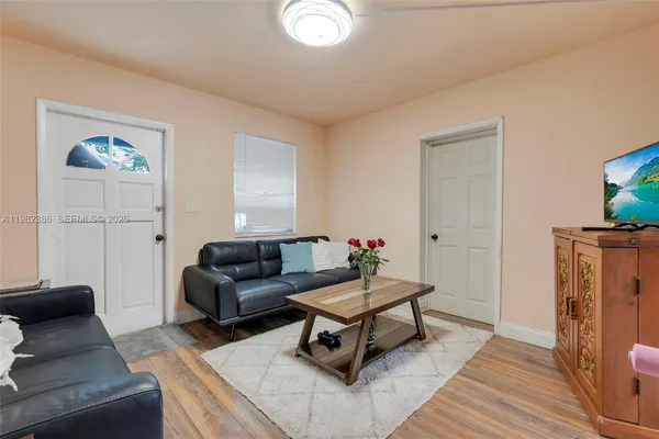 a living room with furniture and a wooden floor