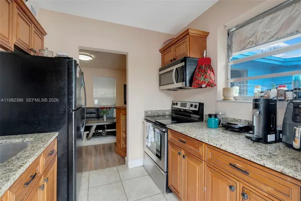 a kitchen with granite countertop a sink and a counter top space