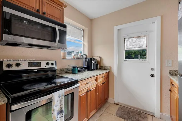 a kitchen with stainless steel appliances a stove a microwave and a sink