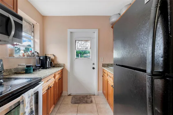 a kitchen with stainless steel appliances granite countertop a refrigerator and a sink