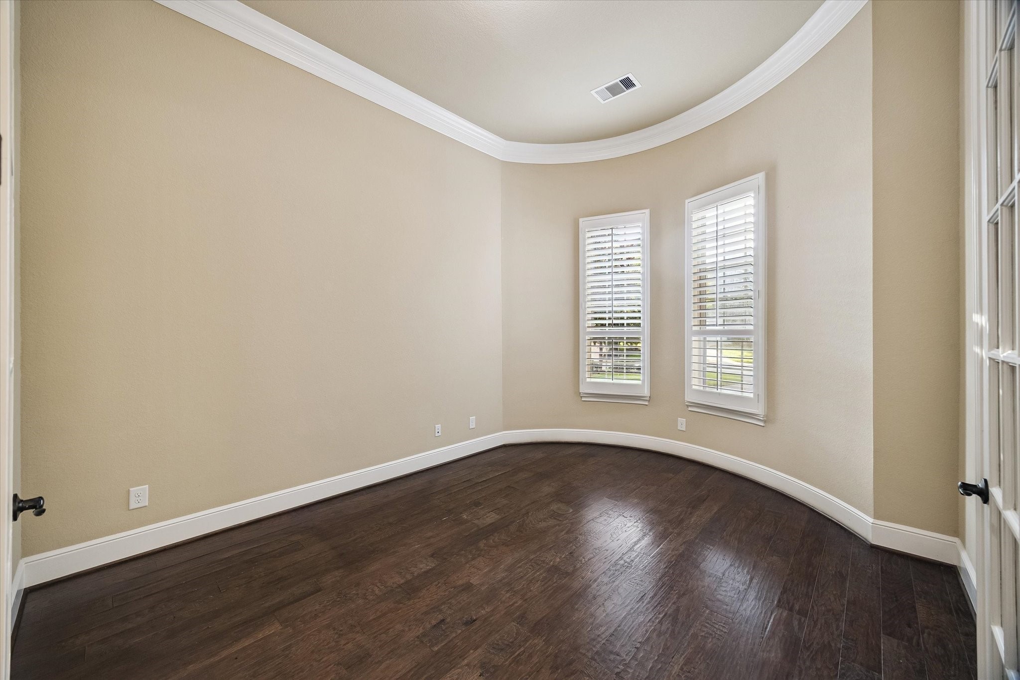 35 North Fremont Ridge Loop Spring, TX 77389 - Photo 6 of 37 Conveniently positioned near the front of the home, this spacious study features elegant French doors, crown molding, rich hardwood flooring, and abundant natural light, creating an ideal setting for a home office or library.