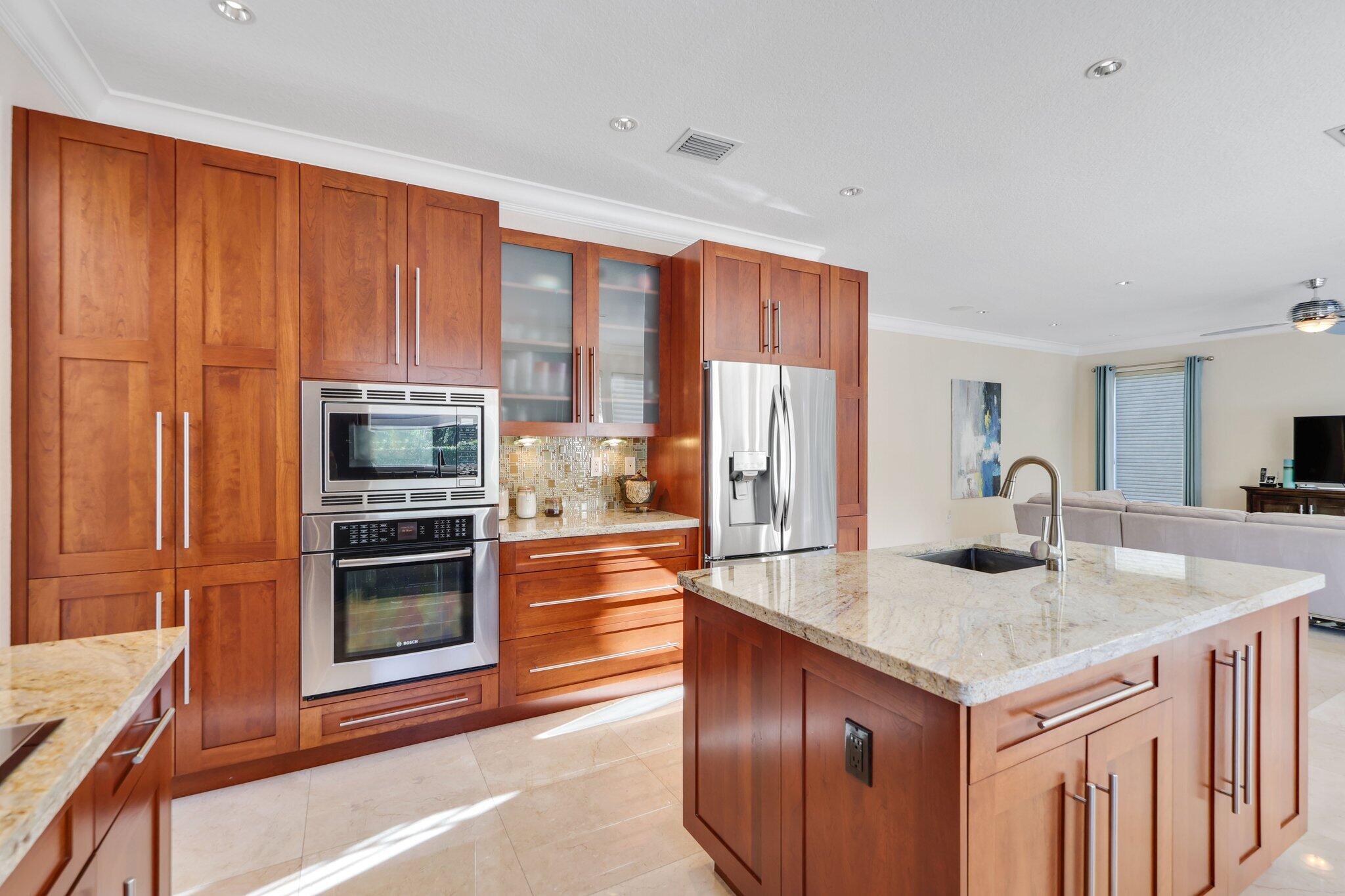 19245 Skyridge Circle Boca Raton, FL 33498 - Photo 31 of 70 a kitchen with stainless steel appliances granite countertop a refrigerator a stove and a sink with wooden floor
