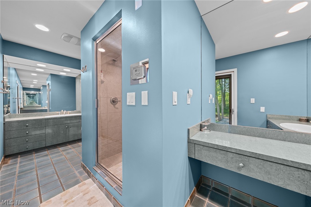 4830 Som Center Road Moreland Hills, OH 44022 - Photo 25 of 48 A primary bathroom built for ease: double vanities and a sleek steam shower stall bring clean, modern style and everyday convenience to your routine.