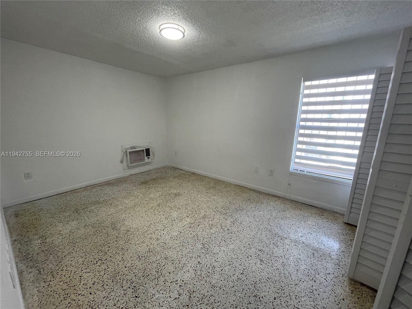 142 Southwest 18th Avenue, Unit 19 Miami, FL 33135 - Photo 12 of 28 an empty room with a window