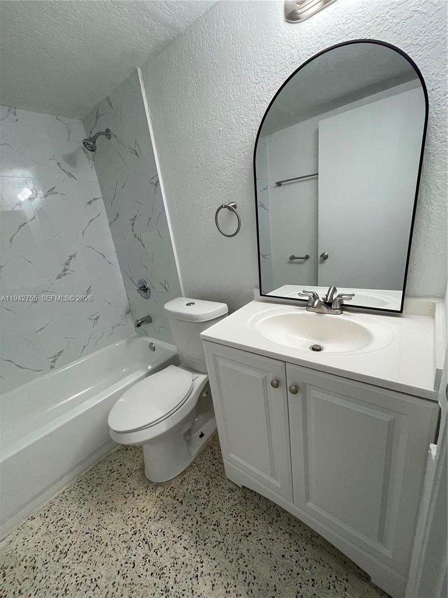 142 Southwest 18th Avenue, Unit 19 Miami, FL 33135 - Photo 19 of 28 a bathroom with a double vanity sink toilet and shower