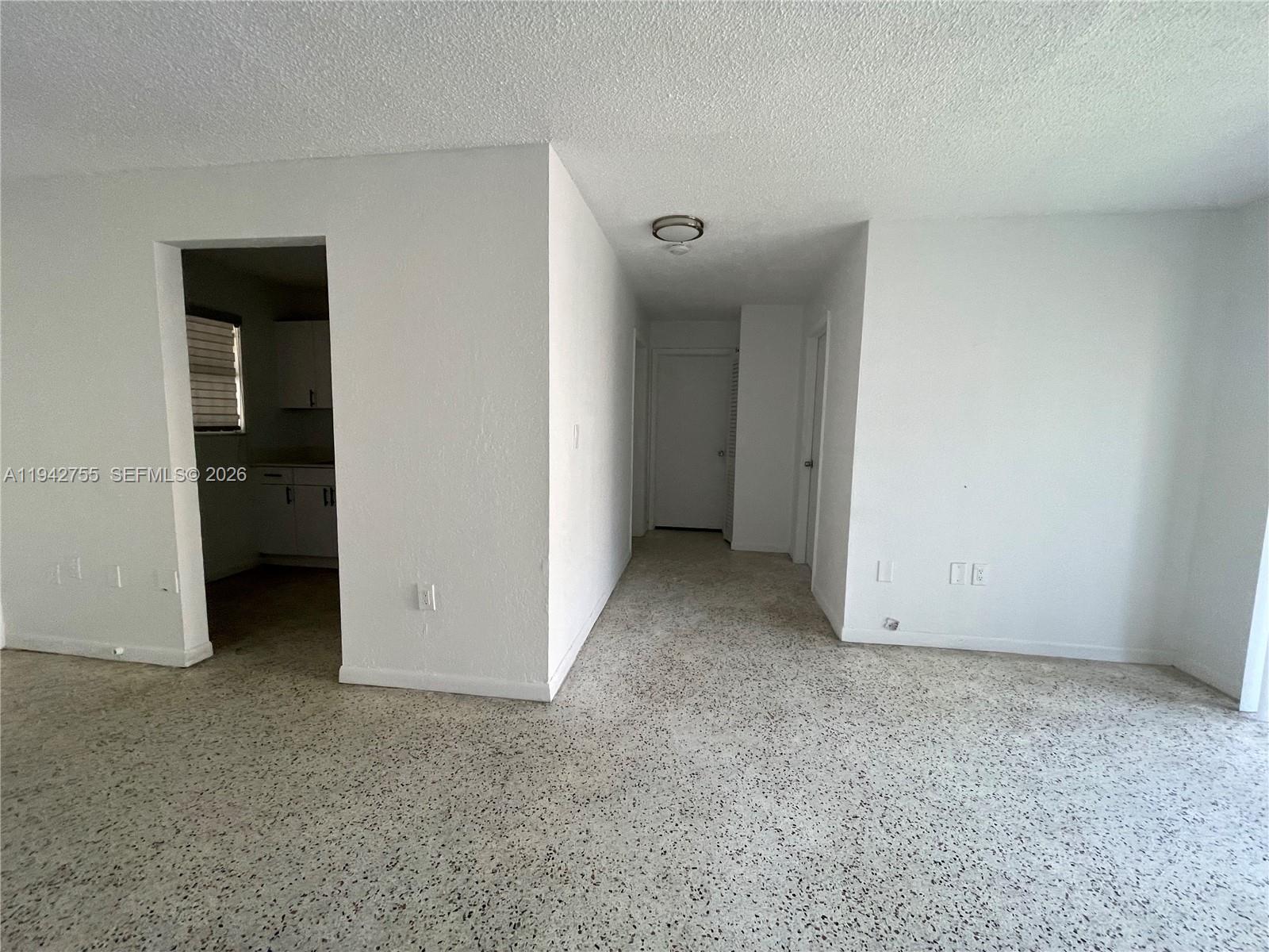 142 Southwest 18th Avenue, Unit 19 Miami, FL 33135 - Photo 25 of 28 an empty room with closet and a white door