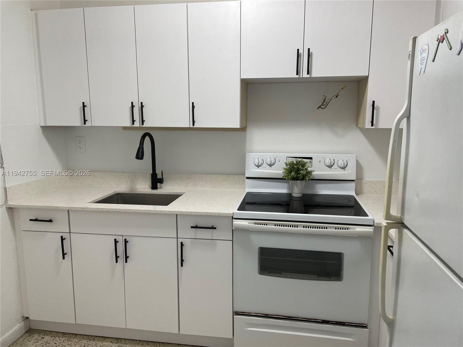 142 Southwest 18th Avenue, Unit 19 Miami, FL 33135 - Photo 4 of 28 a kitchen with cabinets and appliances
