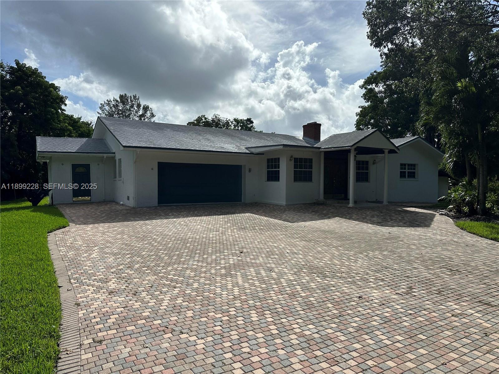 6300 Southwest 181st Lane Southwest Ranches, FL 33331 - Photo 4 of 20 a front view of a house with a garden and a tree