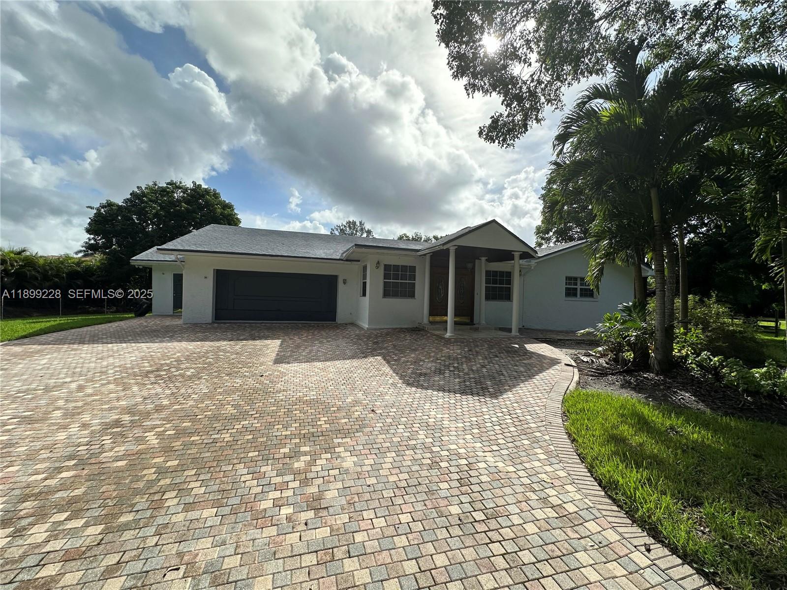 6300 Southwest 181st Lane Southwest Ranches, FL 33331 - Photo 7 of 20 a front view of a house with garden