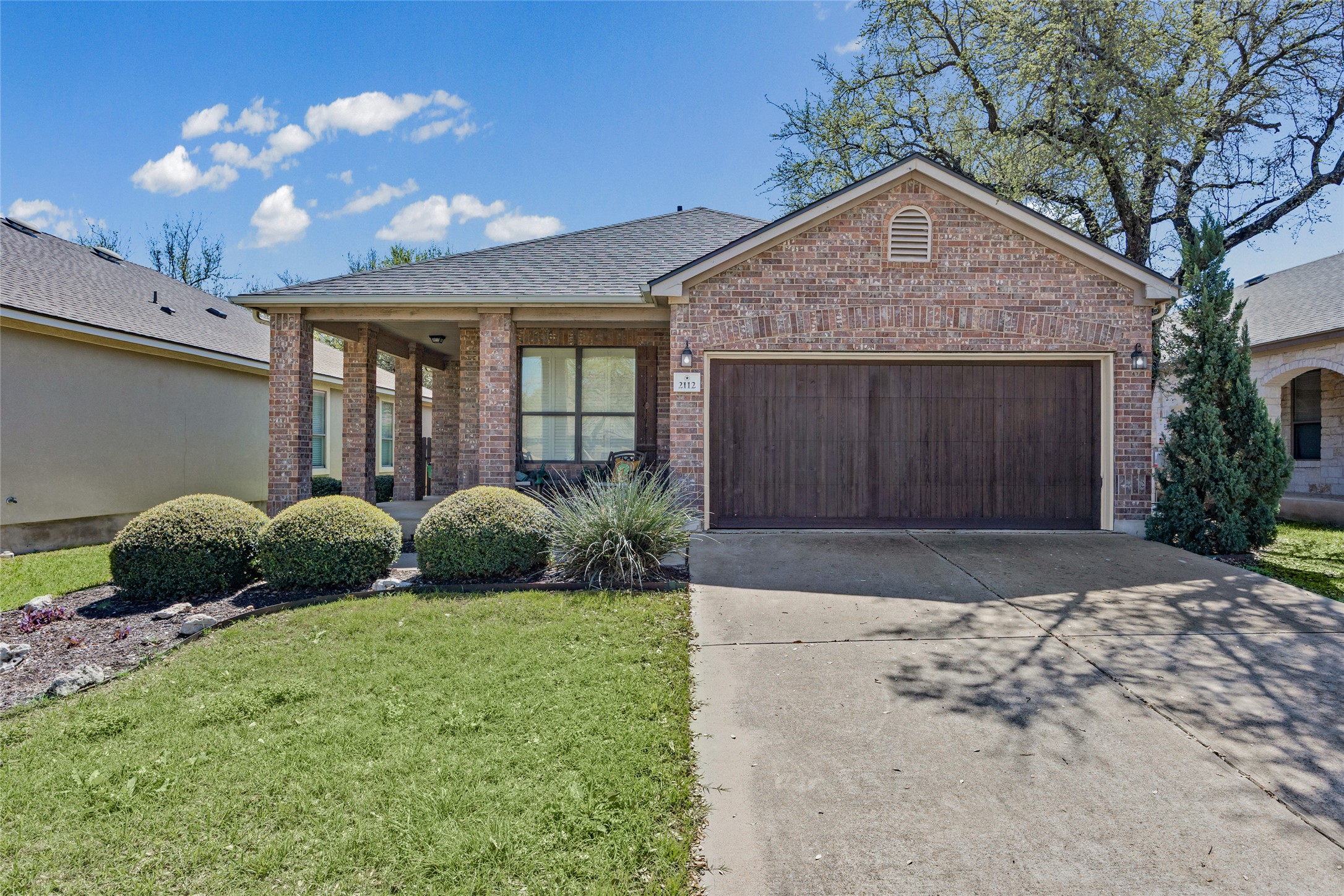 2112 Conn Creek Road Cedar Park, TX 78613 - Photo 1 of 1 Ranch-style home with a garage, concrete driveway, brick siding, a front yard, and a shingled roof