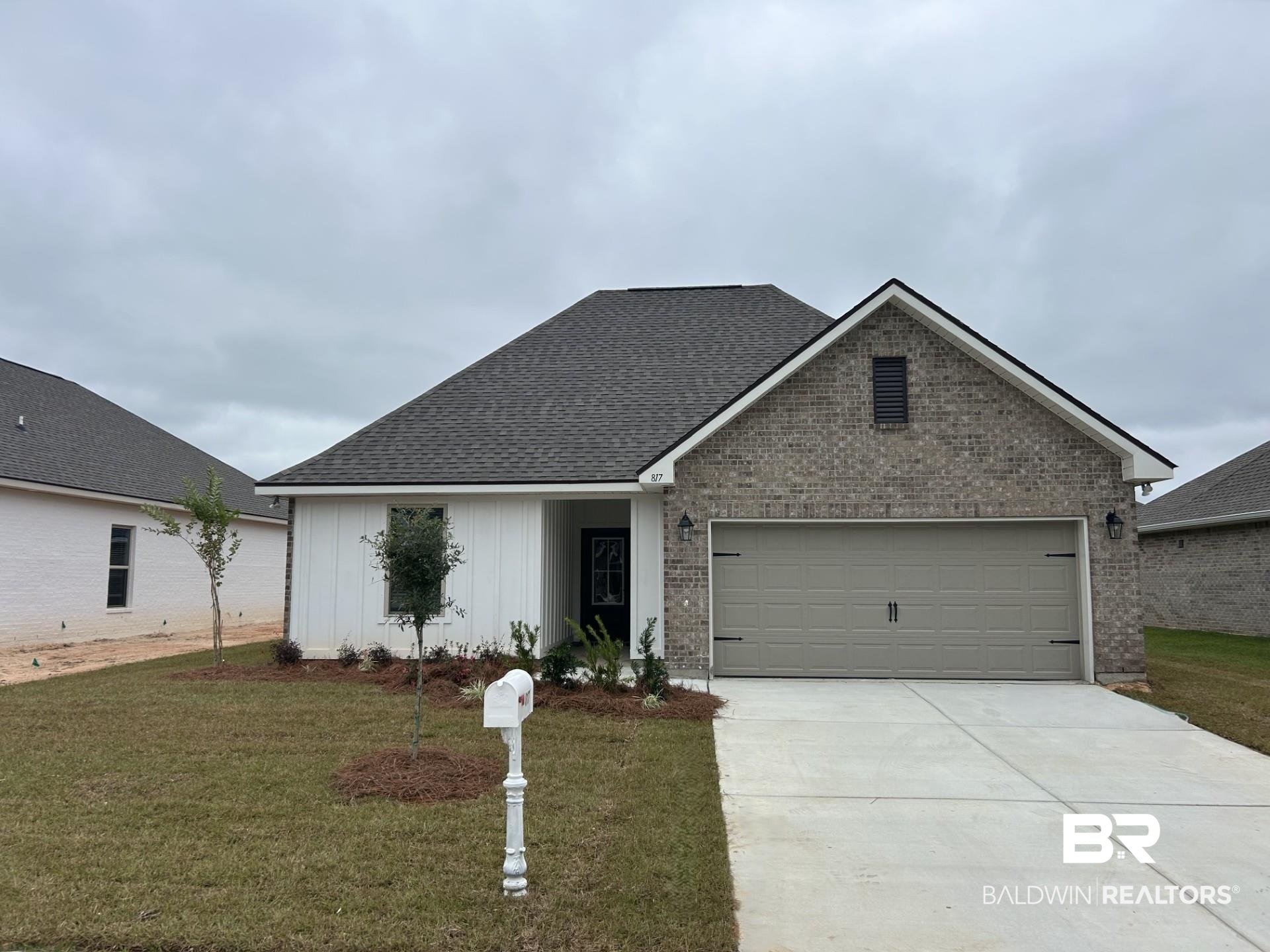 817 Sumter Loop Foley, AL 36535 - Photo 1 of 3 View of front of home with a front yard, brick siding, concrete driveway, and an attached garage