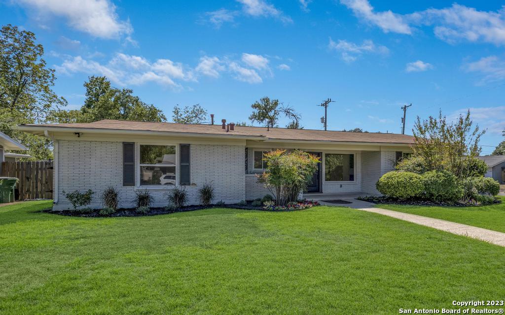 a front view of a house with a yard and porch