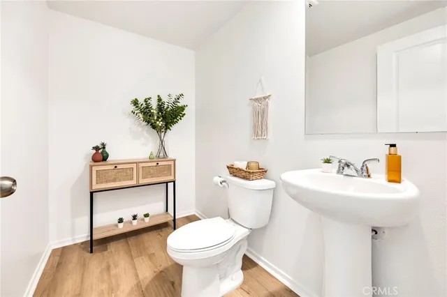 a bathroom with a sink toilet and a mirror