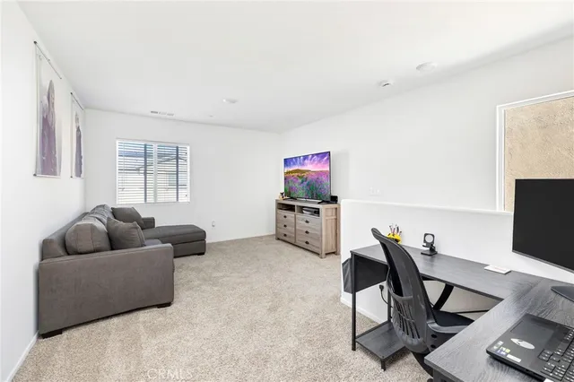 a livingroom with workspace and a couch