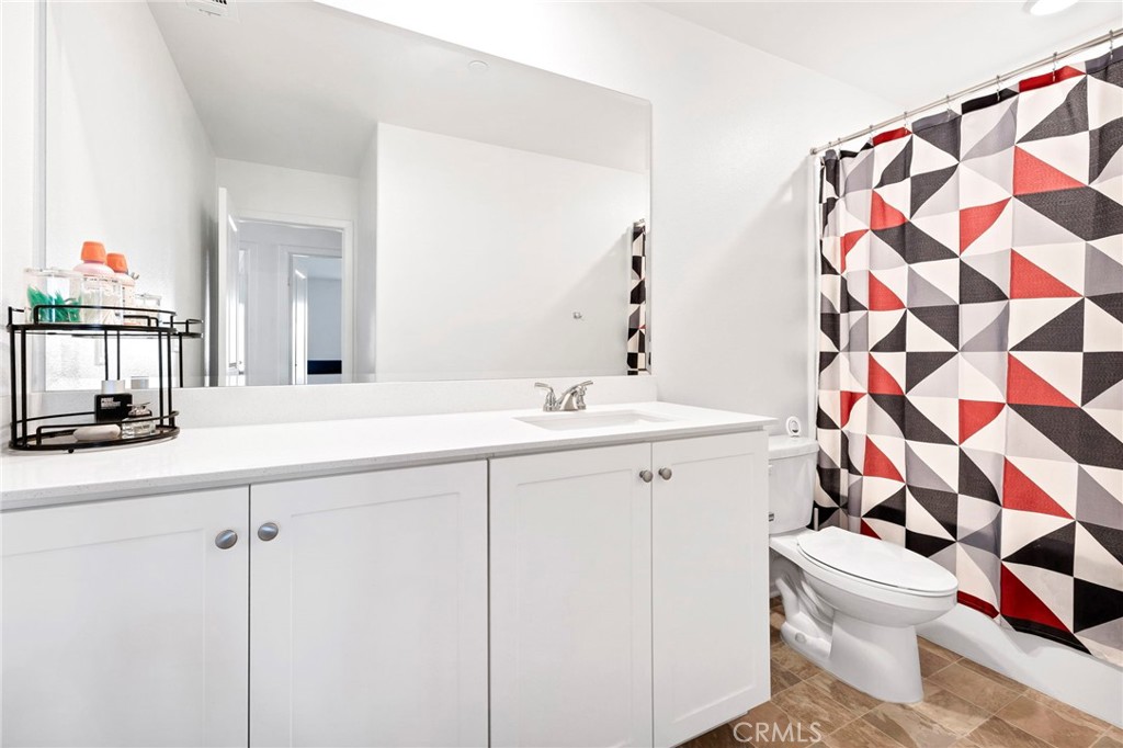1489 Goldenbrush Way Banning, CA 92220 - Photo 21 of 38 a bathroom with a sink a toilet and shower