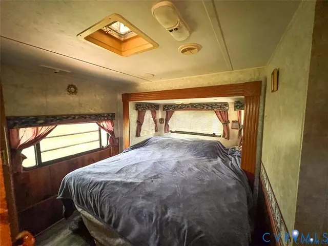 a bedroom with a bed and window