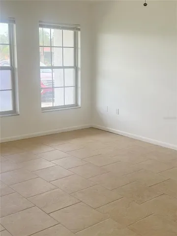 an empty room with a empty space and windows