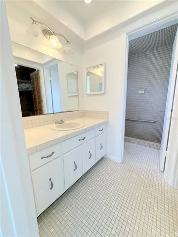 a spacious bathroom with a double vanity sink and a mirror