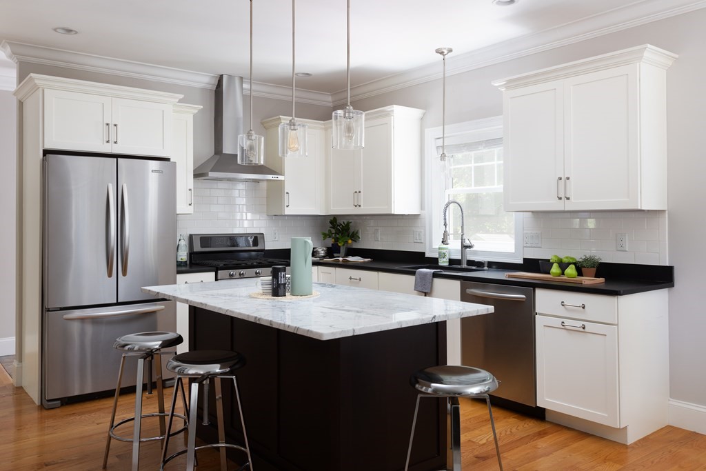 9 Hazel Terrace Arlington, MA 02474 - Photo 11 of 36 a kitchen with stainless steel appliances granite countertop a refrigerator a sink a stove and white cabinets