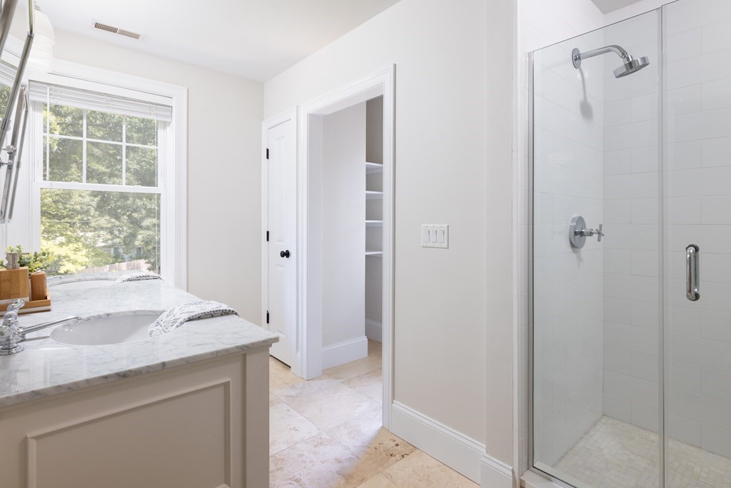 9 Hazel Terrace Arlington, MA 02474 - Photo 16 of 36 a bathroom with a granite countertop sink a mirror and a shower