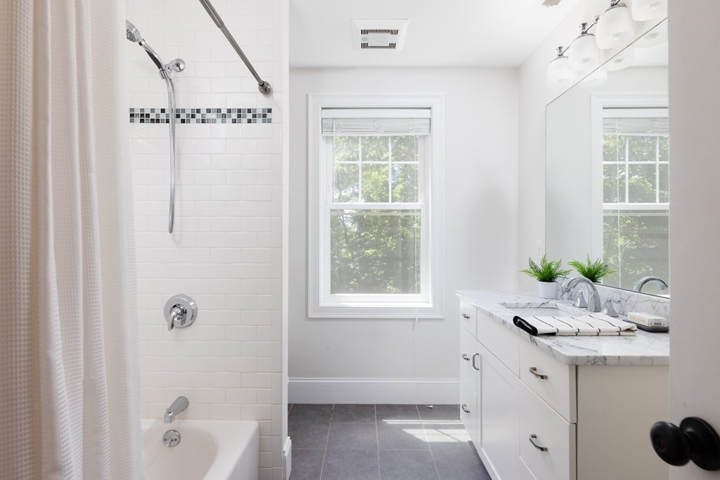 9 Hazel Terrace Arlington, MA 02474 - Photo 17 of 36 a bathroom with a granite countertop sink a mirror and a shower